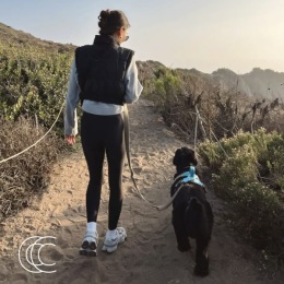 a woman beside her dog